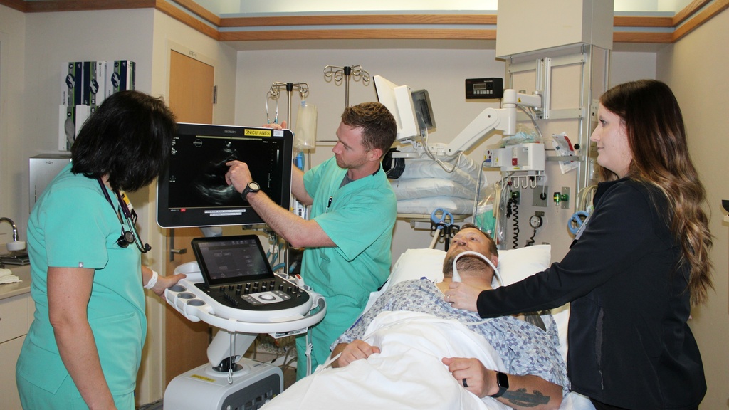 APP group photo with patient and equipment